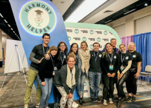 The Harmony Helper team poses in front of their booth at BroadwayCon 2020